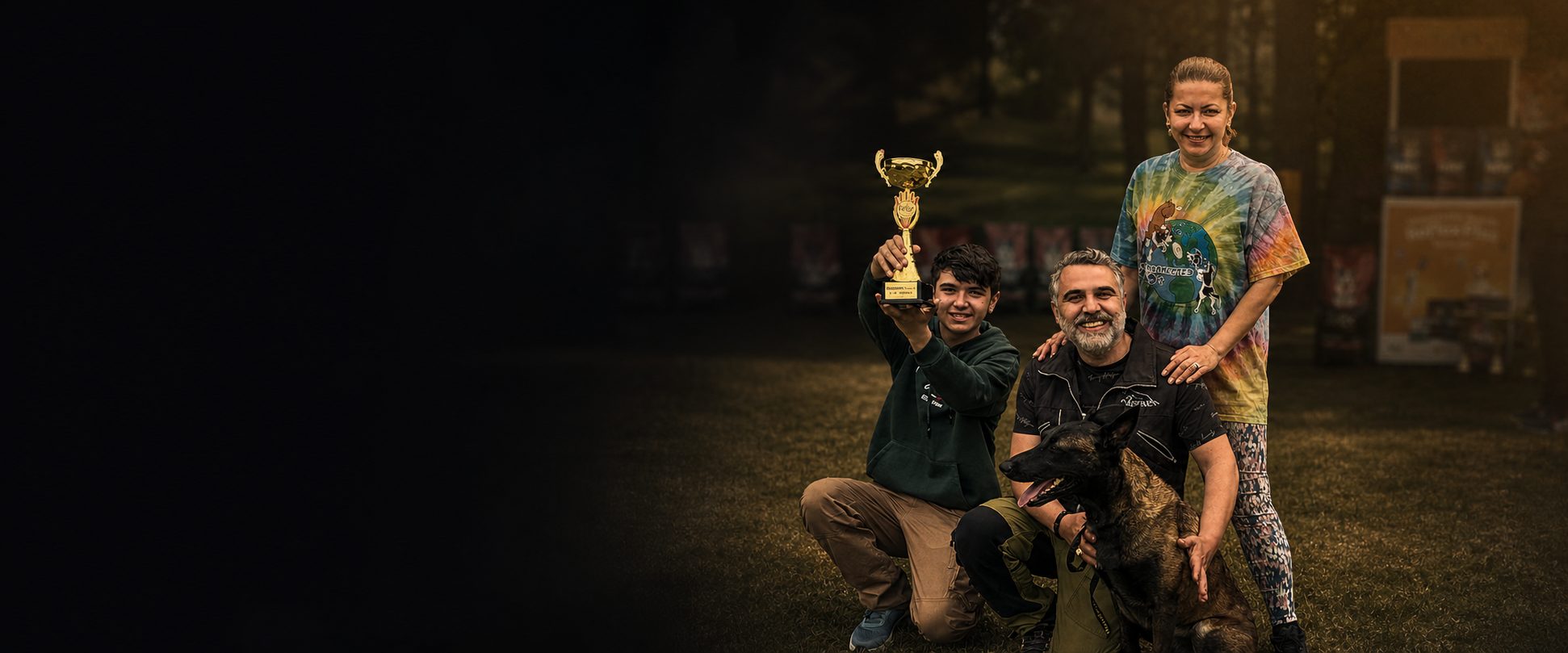 The Üner family celebrating a competition win with their Belgian Malinois